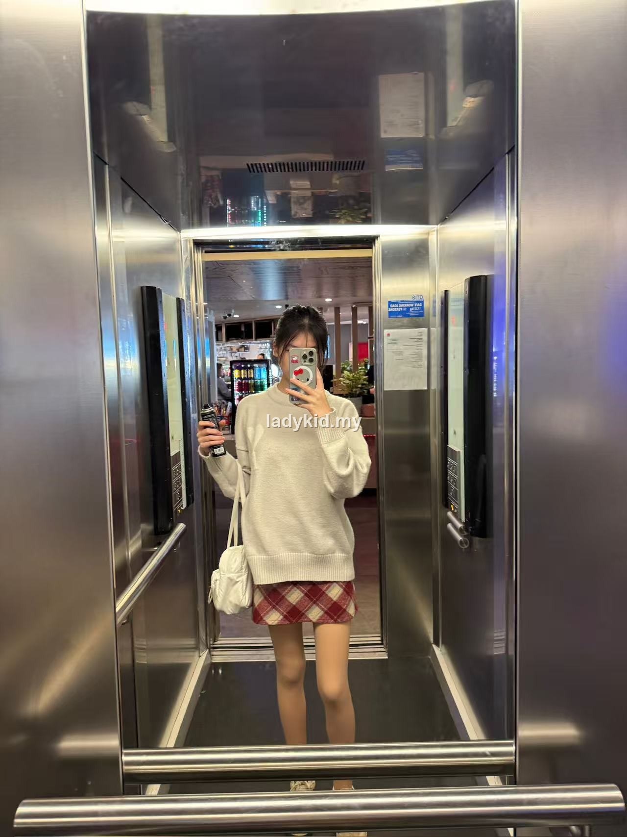 Customer elevator mirror outfit with skin-tone tights